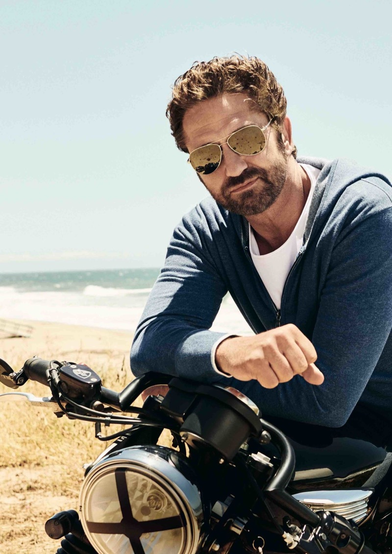 A cool vision, Gerard Butler rocks sunglasses and poses on a motorcycle for OLYMP.