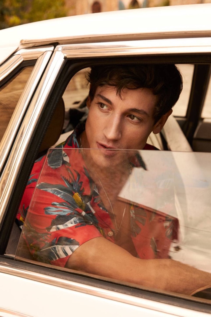 On the move, Nicolas Ripoll sports a red palm print resort shirt $17.99 from H&M.