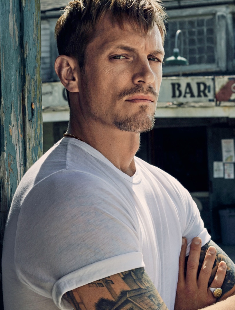 Front and center, Joel Kinnaman sports a white t-shirt in a striking photo.