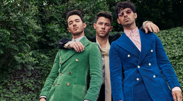 A fashion peacock Kevin Jonas wears a Gucci green suit and blue shirt. Nick Jonas rocks a Gucci black velvet suit and ivory shirt. Rounding out the trio, Joe Jonas wears a Gucci blue velvet suit and stripe shirt.