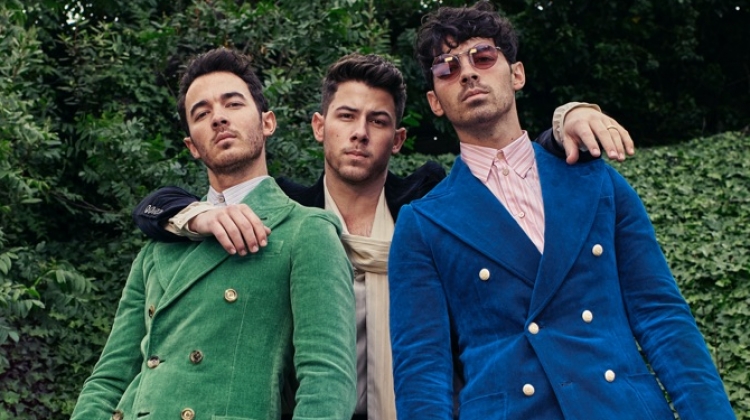 A fashion peacock Kevin Jonas wears a Gucci green suit and blue shirt. Nick Jonas rocks a Gucci black velvet suit and ivory shirt. Rounding out the trio, Joe Jonas wears a Gucci blue velvet suit and stripe shirt.