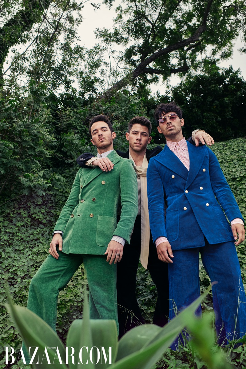 A fashion peacock Kevin Jonas wears a Gucci green suit and blue shirt. Nick Jonas rocks a Gucci black velvet suit and ivory shirt. Rounding out the trio, Joe Jonas wears a Gucci blue velvet suit and stripe shirt.