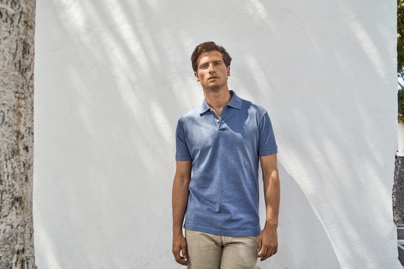 Front and center, Tom Warren dons a steel blue polo from Luca Faloni.