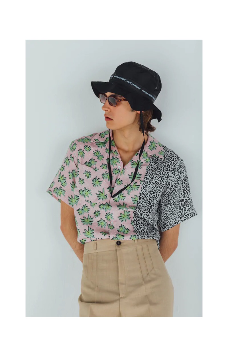 A summer vision, Michele Lanotte models a TDT Tourne De Transmission bucket hat $166, AMIRI palm and leopard print shirt $595, Maison Margiela pleated trousers $696, and Flatlist Eyewear sunglasses $255.