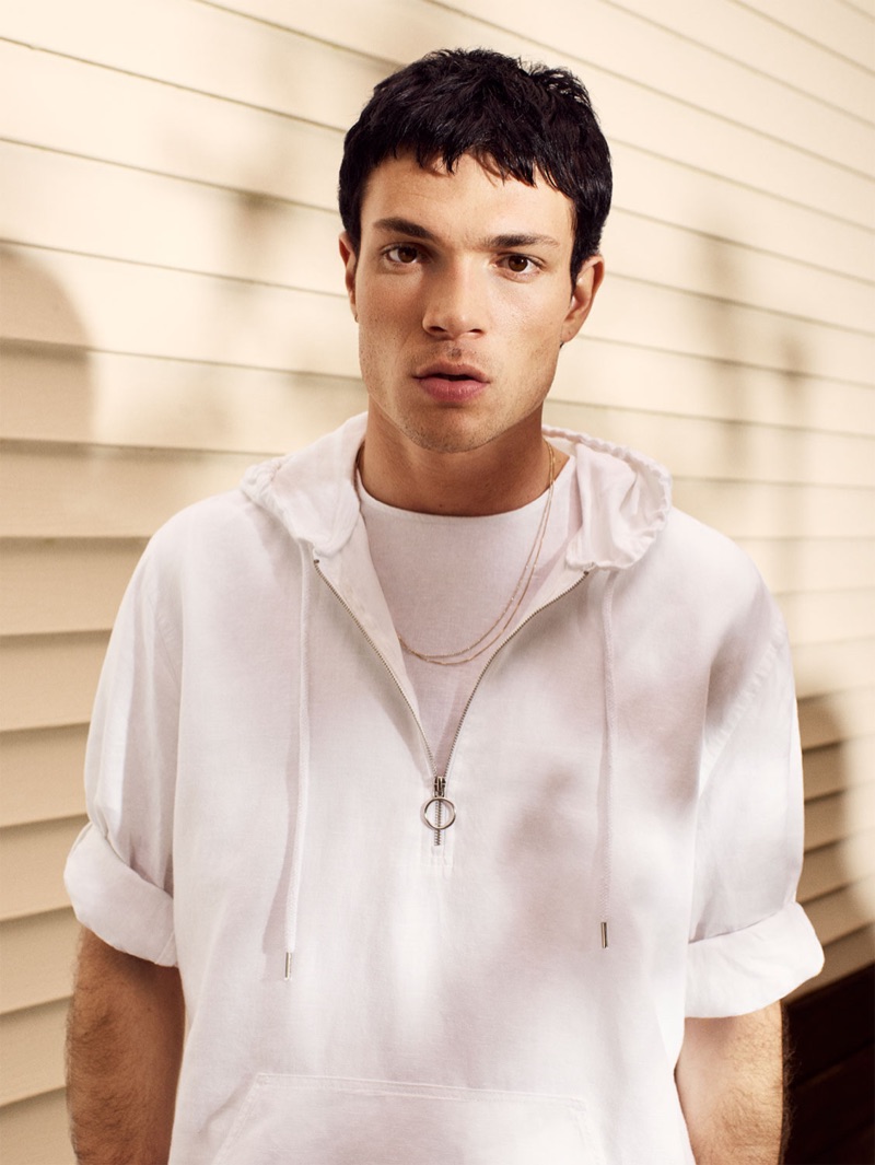 Model Luka Isaac rocks a white half-zip pullover from Zara.