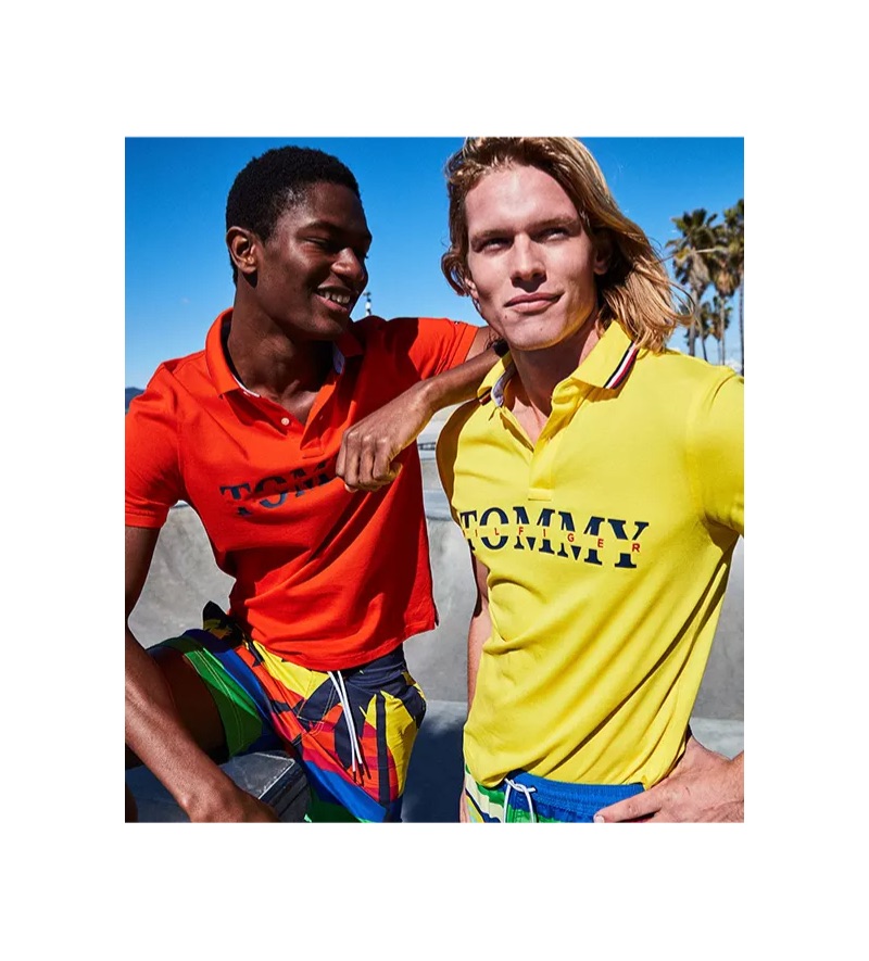 Models Hamid Onifade and Hunter Bach wear colorful Tommy Hilfiger logo polo shirts $59.50.