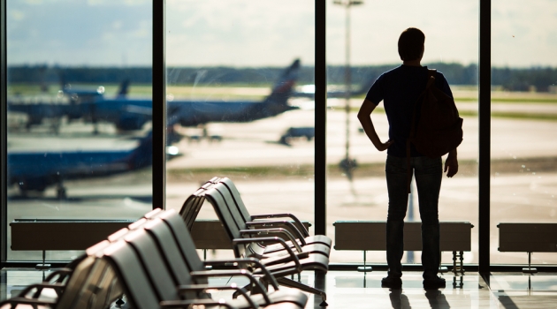 Absolute Necessities for an International Flight Man at Airport Silhouette