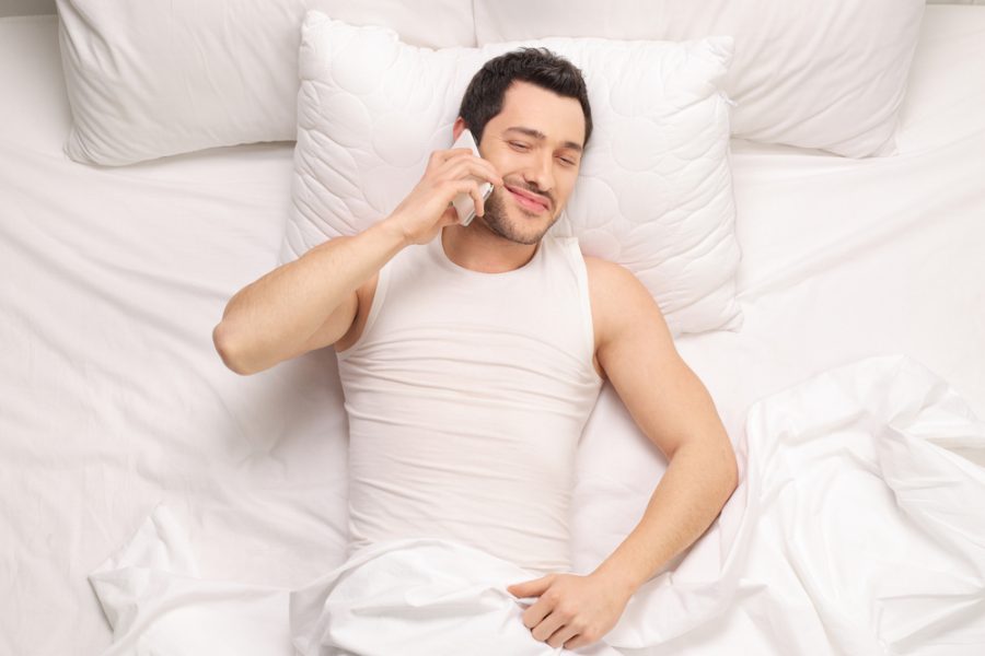 Man in Bed Talking on Phone Man in Bed Talking on Phone