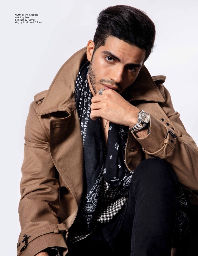 Aladdin star Mena Massoud wears an outfit by The Kooples with a Rolex watch, Pyrrha necklace, and Clocks and Clours ring.