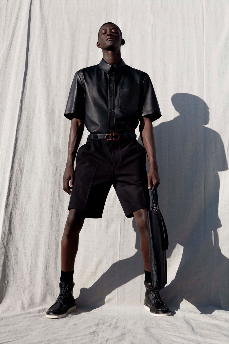 Oumar Diouf models a chic leather shirt with shorts from Salvatore Ferragamo's pre-spring 2020 collection.
