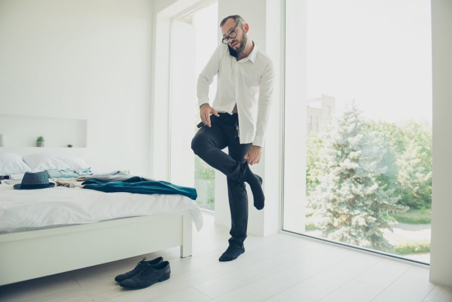 Stylish Man Putting on Socks