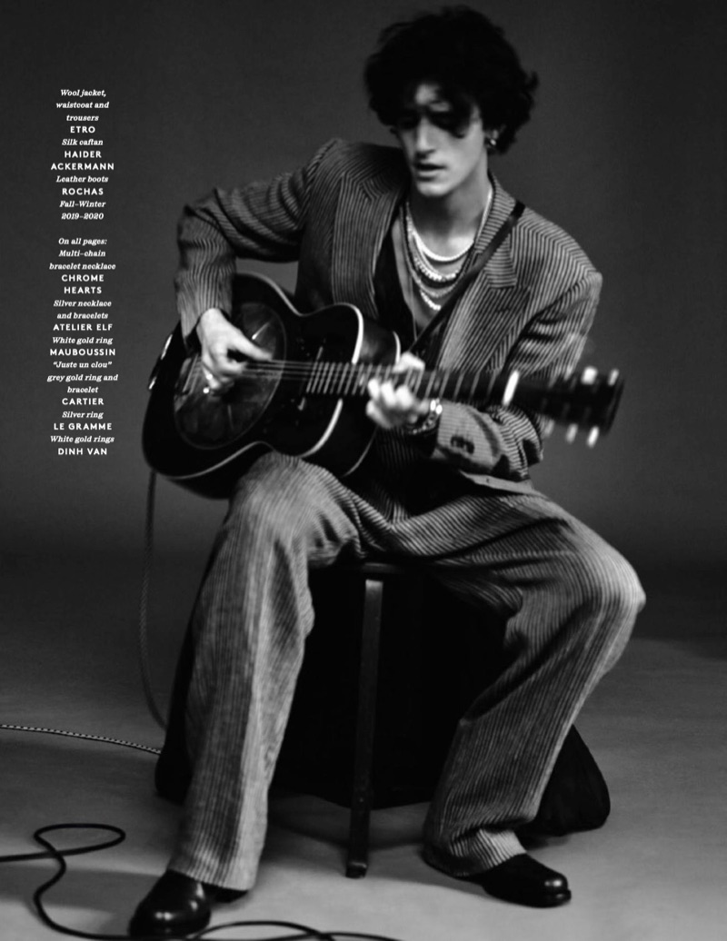 Connecting with Vogue Hommes Paris, Tamino dons a wool jacket, waistcoat, and trousers by Etro. He also wears a Haider Ackermann caftan and Rochas leather boots.