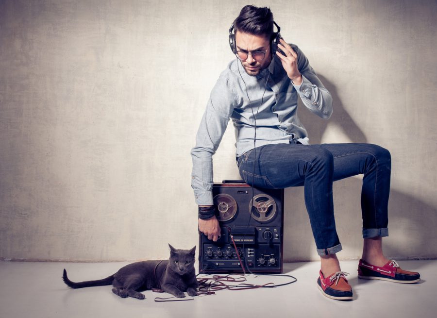Trendy Man Listening to Music with Cat