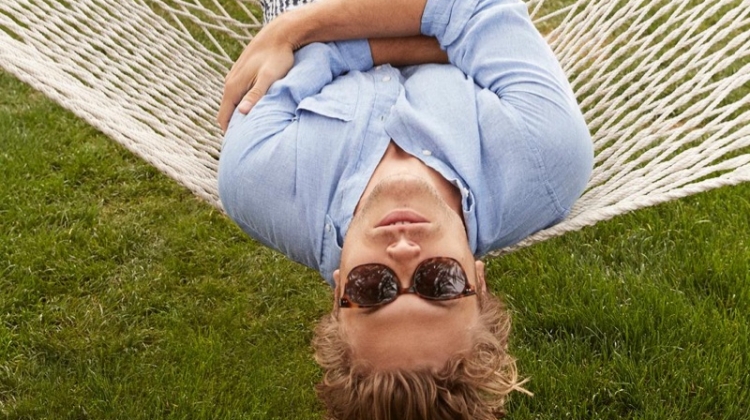 Taking in a relaxing day in Palm Springs, Christopher Mason dons Warby Parker's Tilden acorn tortoise with gold sunglasses.