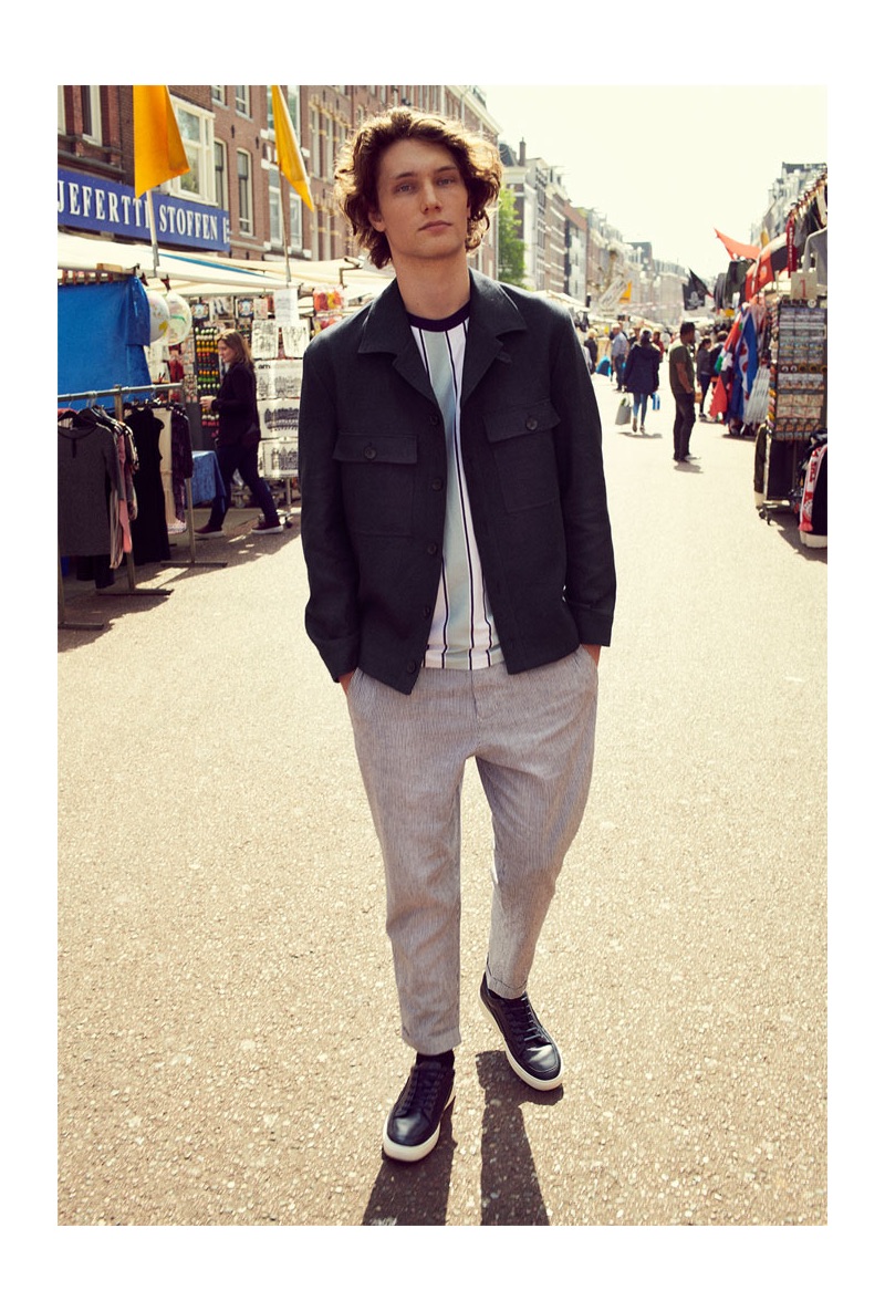 Johannes Spaas steps out in a smart jacket, vertical striped t-shirt, pants, and sneakers from Zara.