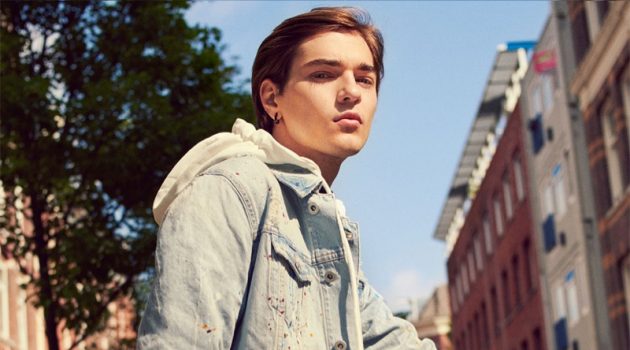 Zara Tackles Casual Summer City Style Felix Prabitz sports a denim jacket with a hooded sweatshirt, jumpsuit, and sneakers by Zara.