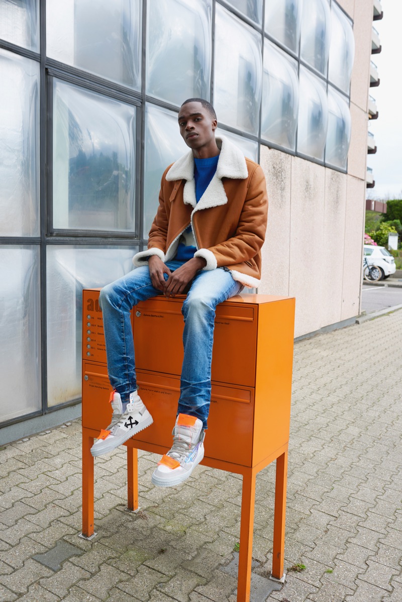 Going casual, Bakay Diaby models a Benedetta Novi jacket with a sweater by The Elder Statesman. He also sports AMIRI jeans and Off-White sneakers.