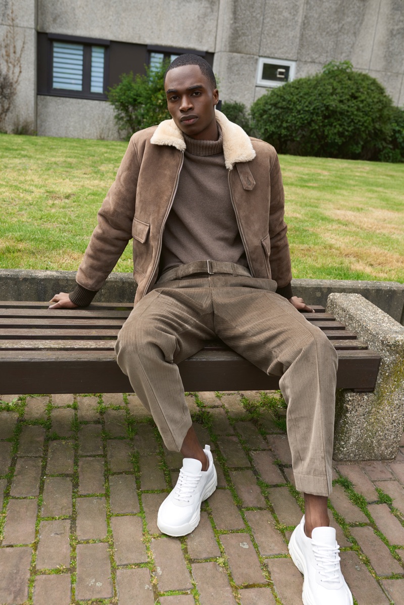 Embracing a monochromatic ensemble, Bakay Diaby wears an Officine Générale look with Valentino sneakers.