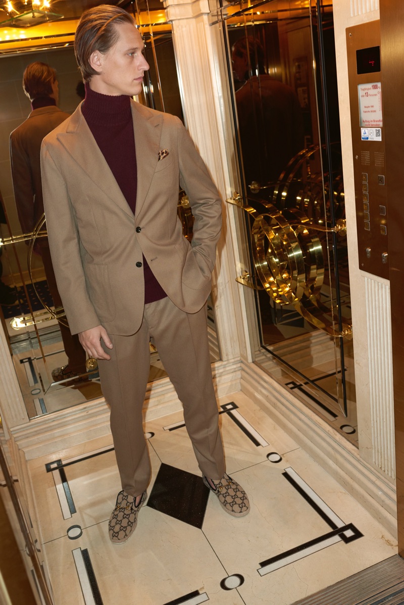 Donning neutrals, Rogier Bosschaart wears a Caruso suit and turtleneck sweater with Gucci loafers.