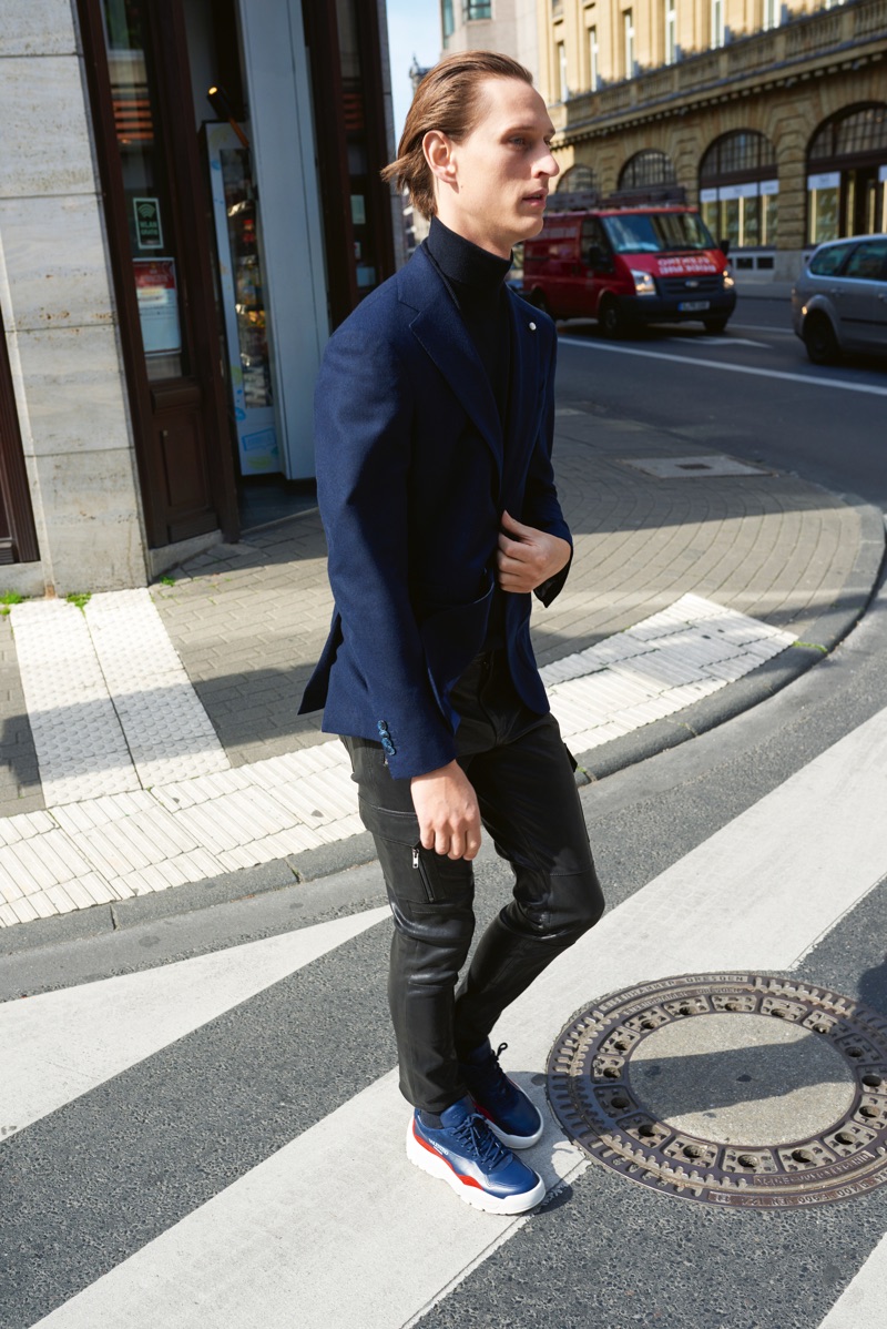 Top model Rogier Bosschaart rocks a Luigi Bianchi Mantova blazer with a Filippo de Laurentis sweater, Arma pants, and Valentino sneakers.