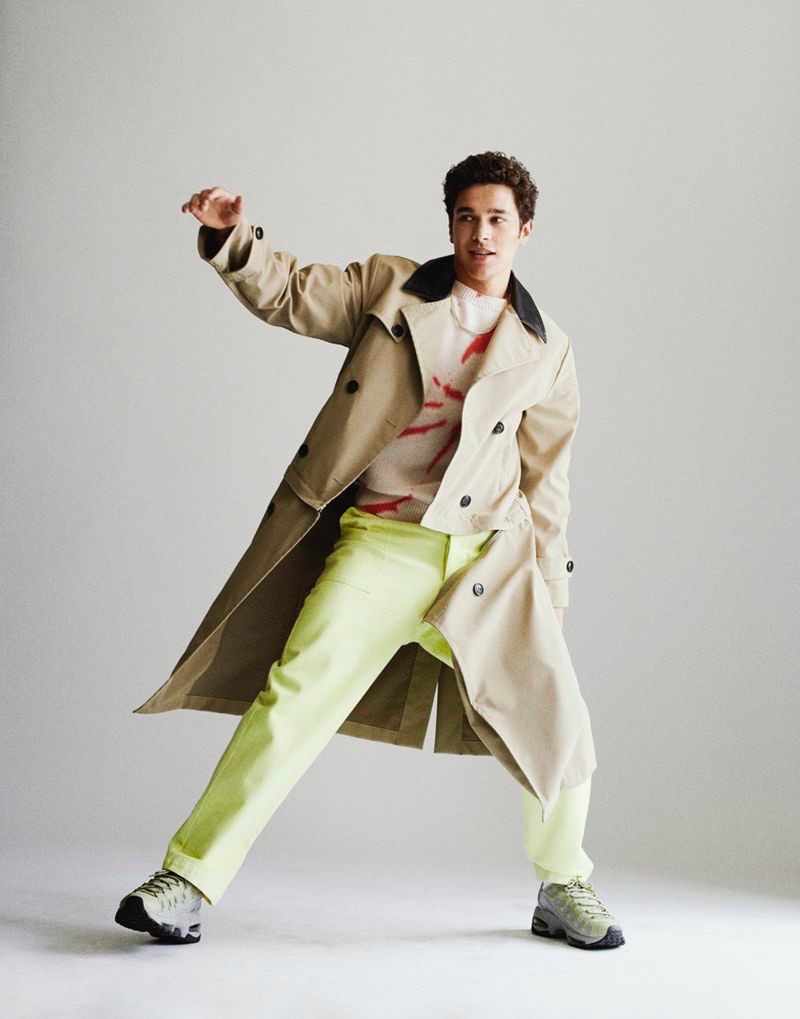 Starring in a photo shoot, Austin Mahone wears an AMIRI trench coat with PUMA sneakers and pants by The Elder Statesman.