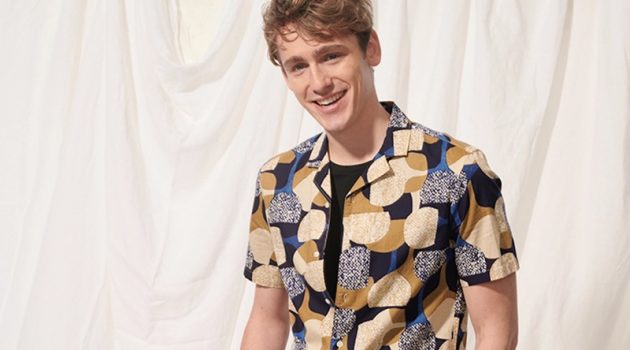 Tom Webb Charms in Club Monaco Summer Arrivals All smiles, Tom Webb wears a Club Monaco notched collar moon print shirt $89.50 and 7" shorts $89.50.
