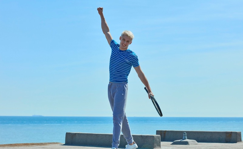 Embracing sporty style, João Knorr rocks a striped tee with joggers from Derek Rose.