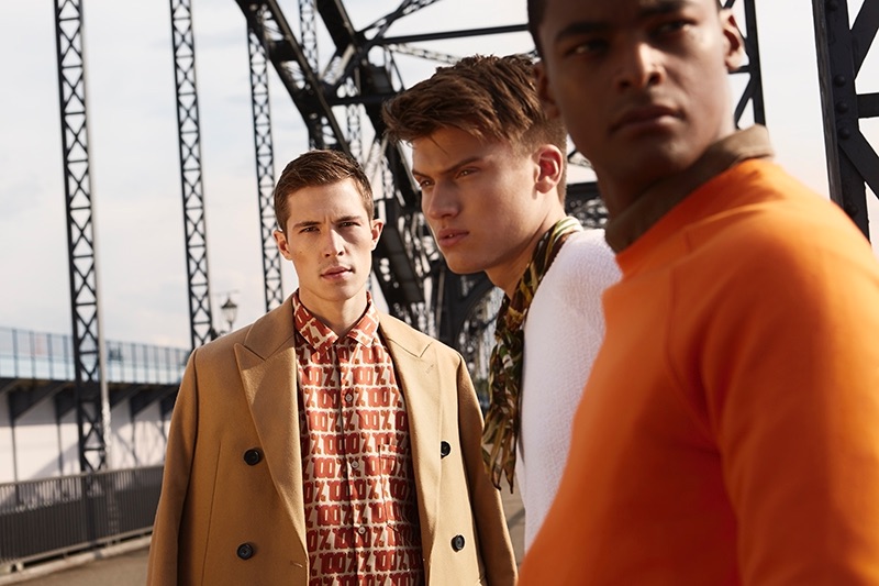 Left to Right: Aaron wears coat Arket and shirt Weekday. Leon wears pullover Weekday. Eugon wears orange pullover Weekday and shirt Teddy Glickman.
