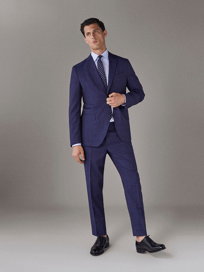 Garrett Neff dons a blue suit by Massimo Dutti.