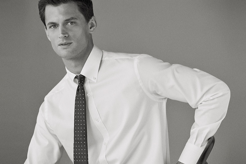 Captured in a black and white photo, Garrett Neff wears a shirt and tie from Massimo Dutti.