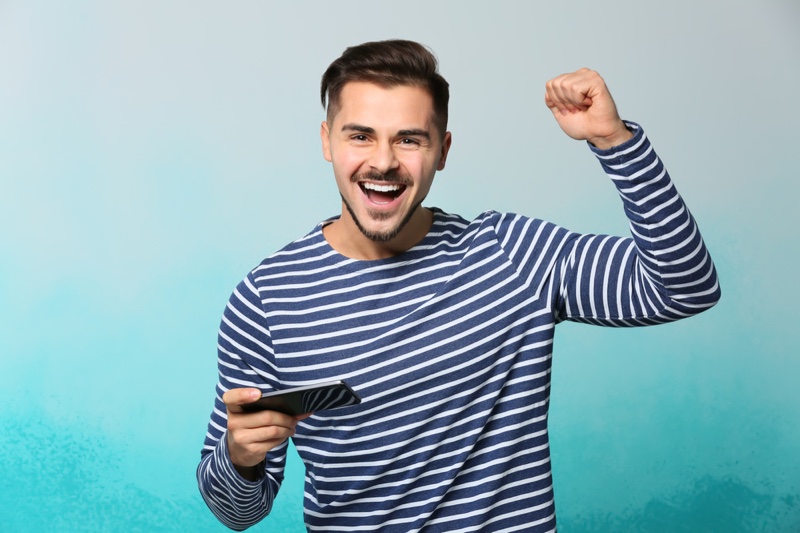 Guy Celebrating Mobile Game Striped Shirt