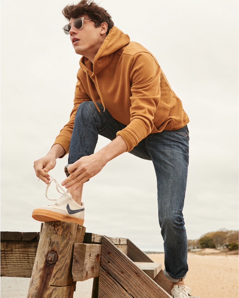 Going casual, Nicolas Ripoll sports a J.Crew mustard yellow hoodie $79.50, striped t-shirt $29.50, and 484 slim-fit jeans $128 with Nike for J.Crew Killshot 2 sneakers $90.