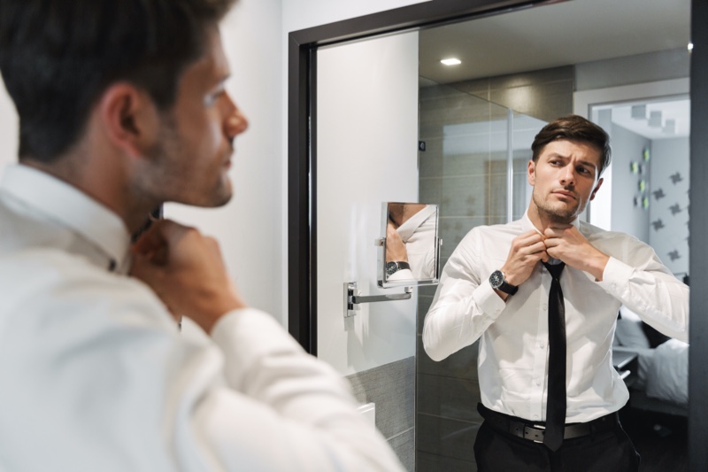 Man Putting on Tie