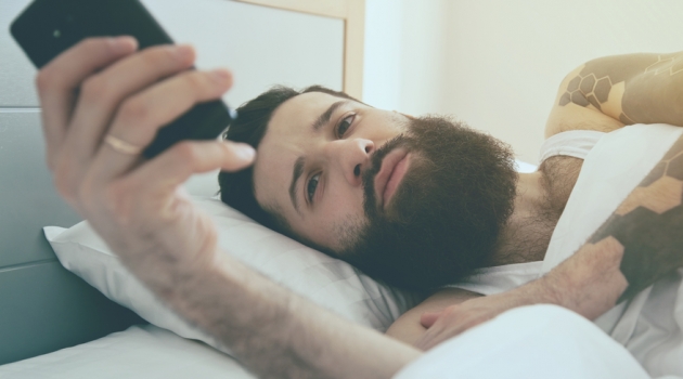 Tips for Becoming an Influencer Man with Beard in Bed Taking Selfie on Phone