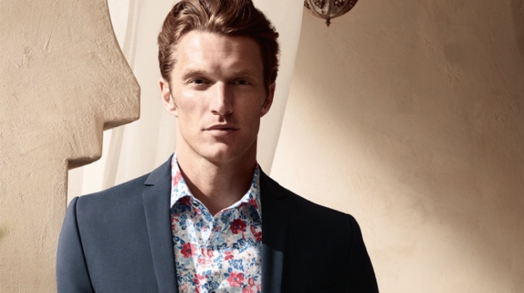 Shaun Dewet wears a floral print shirt with a smart blazer from OLYMP.