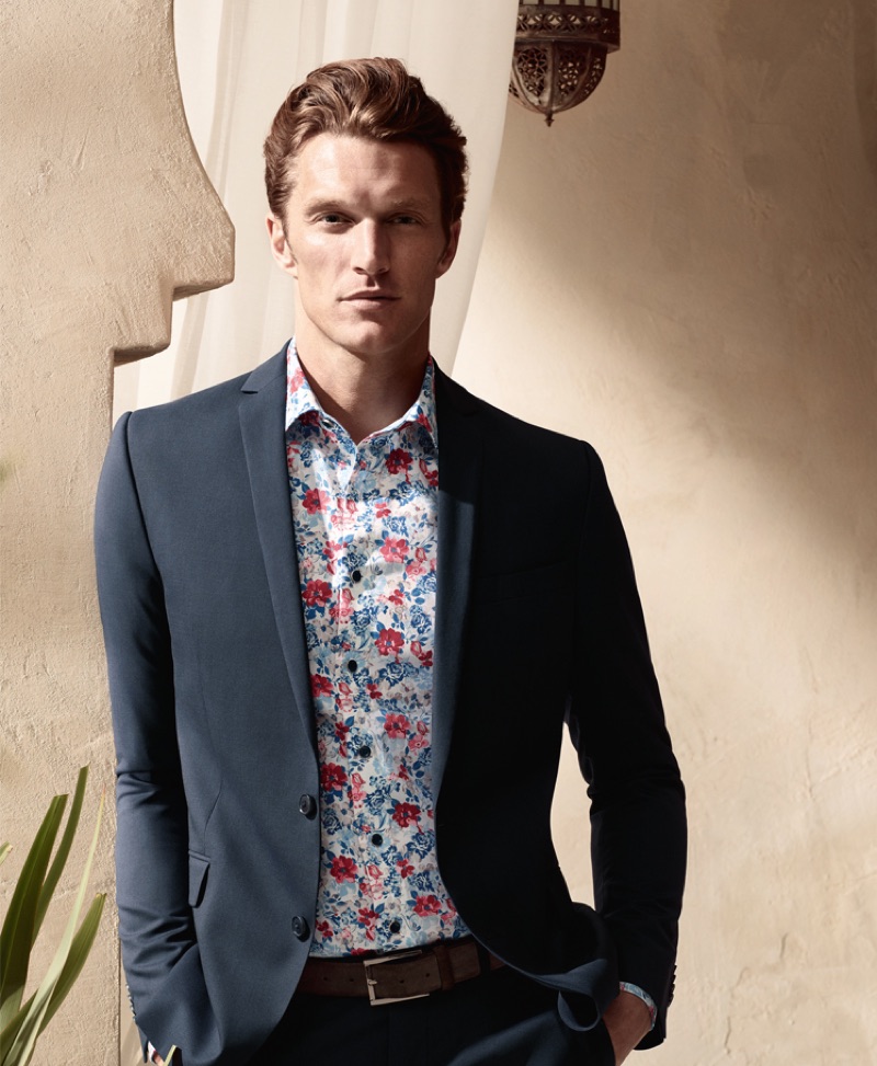 Shaun Dewet wears a floral print shirt with a smart blazer from OLYMP.
