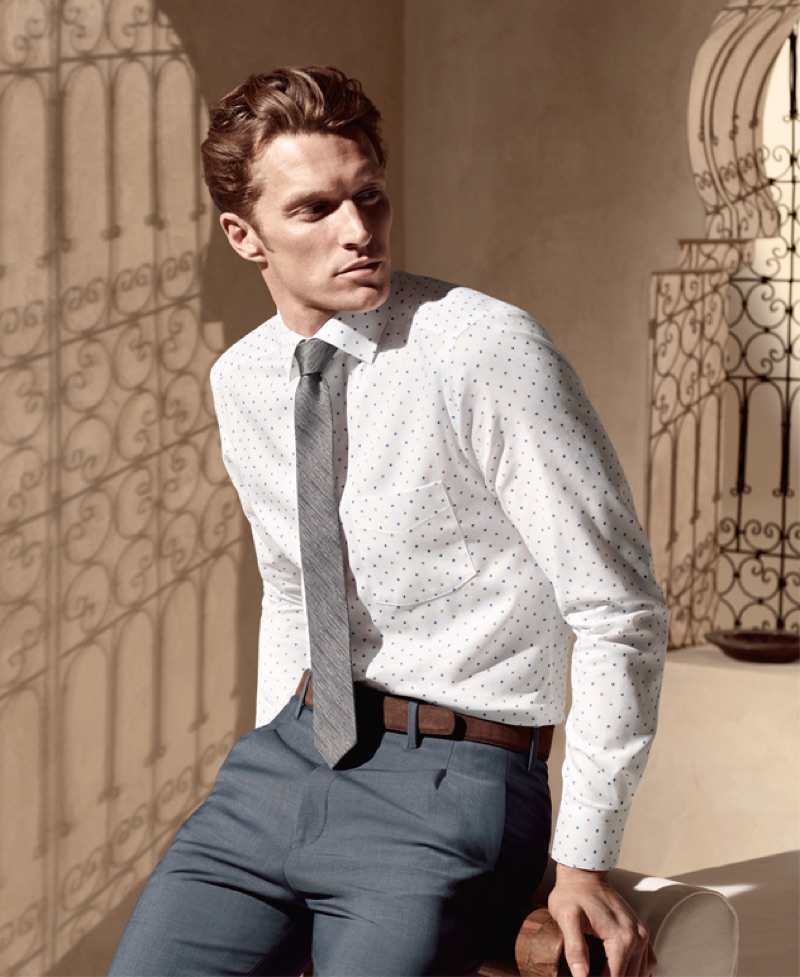 A smart vision, Shaun Dewet wears a shirt, tie, and trousers by OLYMP.