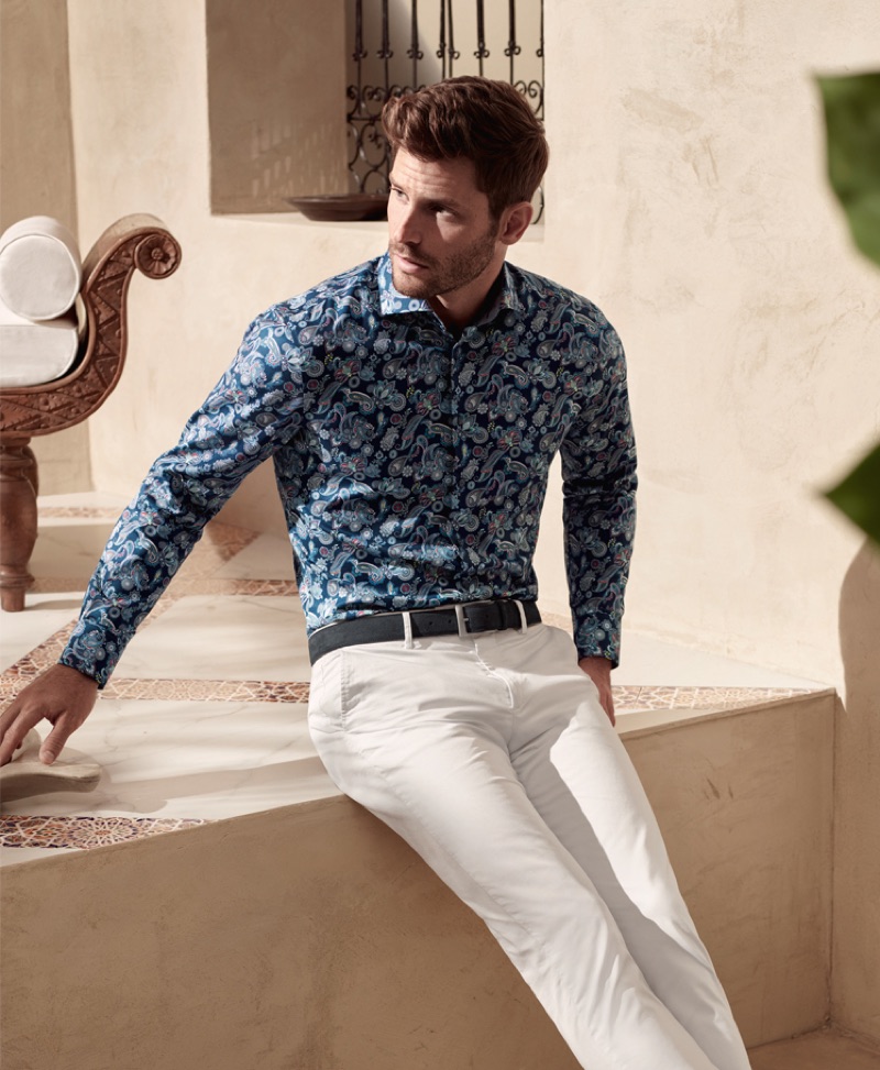 Samuel Trepanier is dashing in a paisley print shirt and light colored pants from OLYMP.