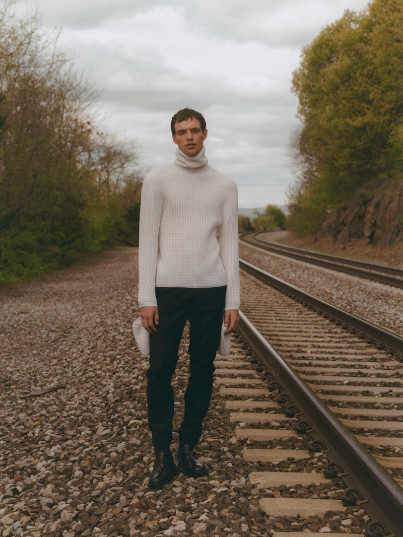 Front and center, Rocky Harwood dons a sweater and trousers by Bottega Veneta with Prada boots.