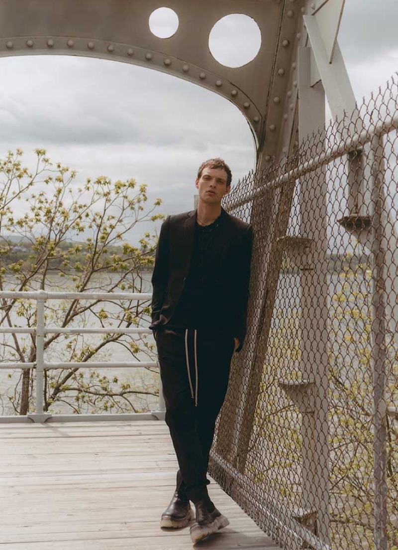 Donning dark style, Rocky Harwood wears a Rick Owens jacket, trousers, and boots with a Craig Green t-shirt.