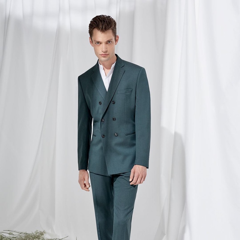 Donning a double-breasted suit, Nick Rea models Selected Homme.