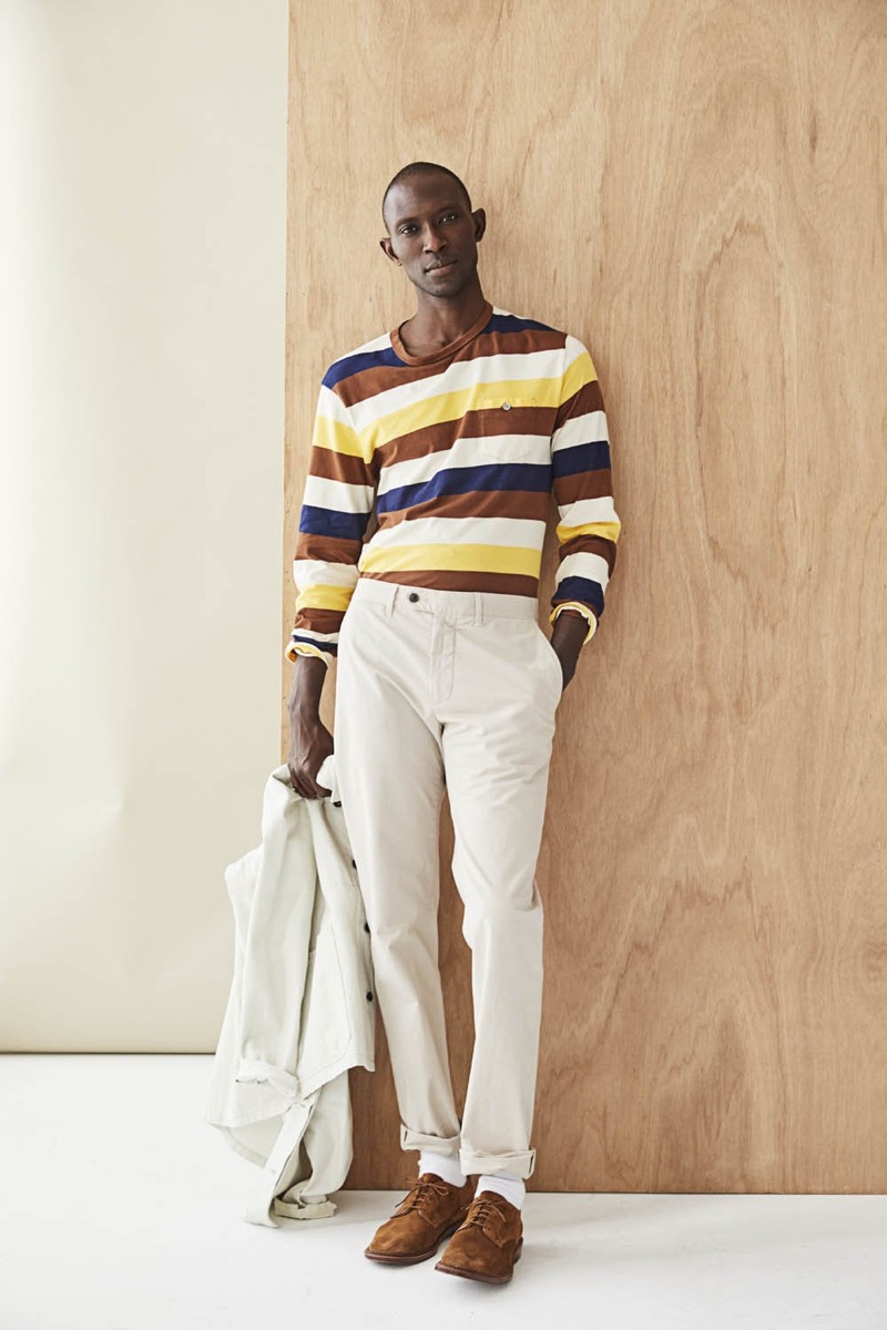 Making a colorful statement, Armando Cabral dons a bold long-sleeve striped tee $98.