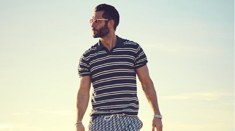 Summer Polo: Life may not actually be a beach, but with the right polo, it can sure feel like it. Taking to the beach, John Halls wears Todd Snyder's striped bouclé polo $139 in navy with Hartford geometric print swim shorts $198.