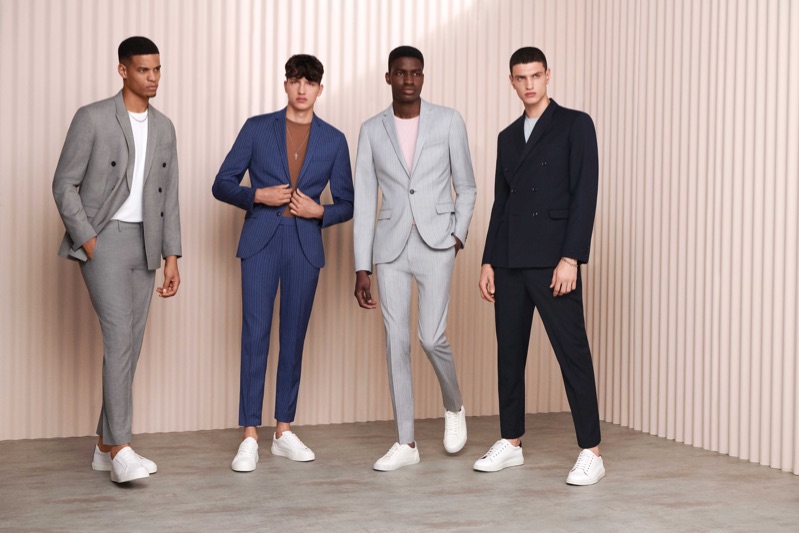 Models Glen Abrantes, Romain Hamdous, Michael Oladayo Chima, and Azim Osmani don suits with white sneakers from Topman.