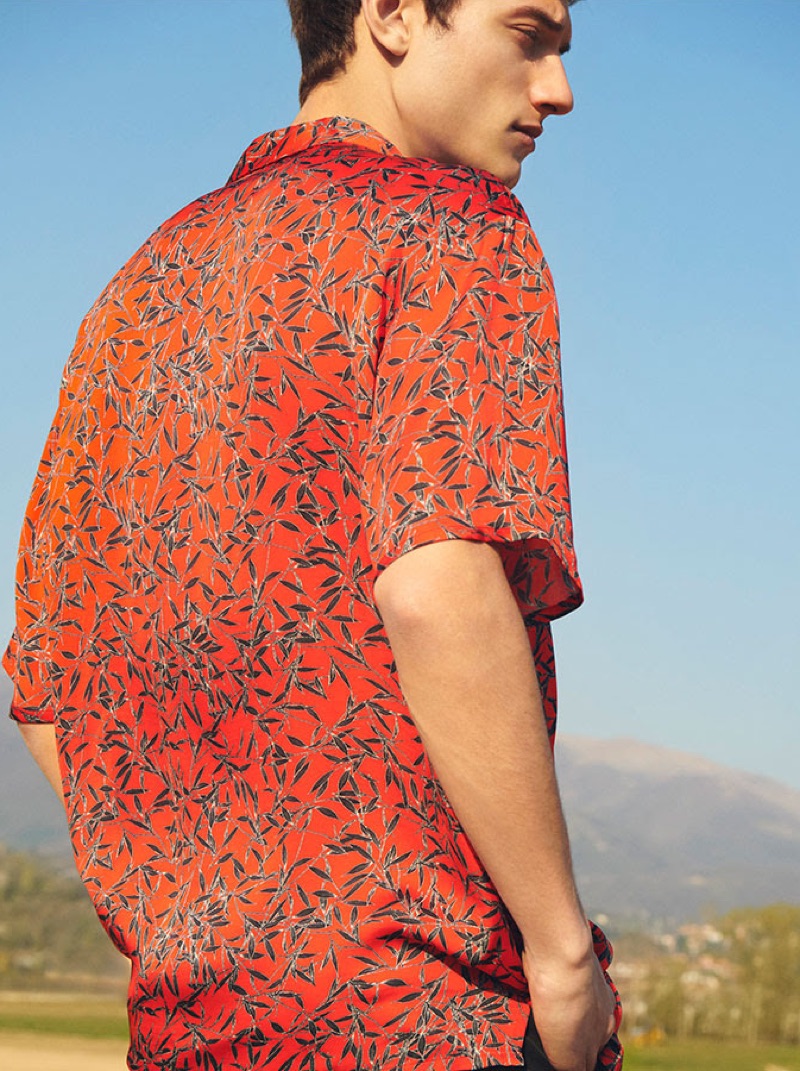 Standing out in red, Serge Rigvava dons a printed shirt by Represent.