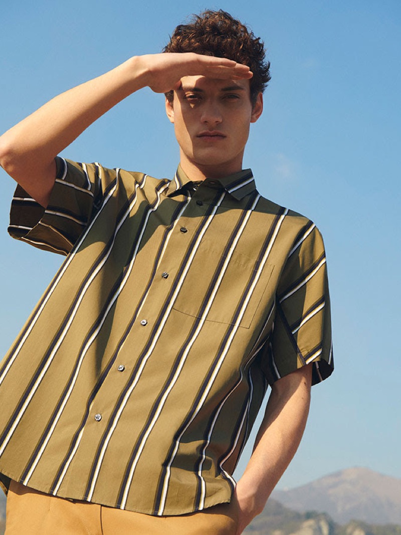 Serge Rigvava sports a striped short-sleeve shirt by OAMC.