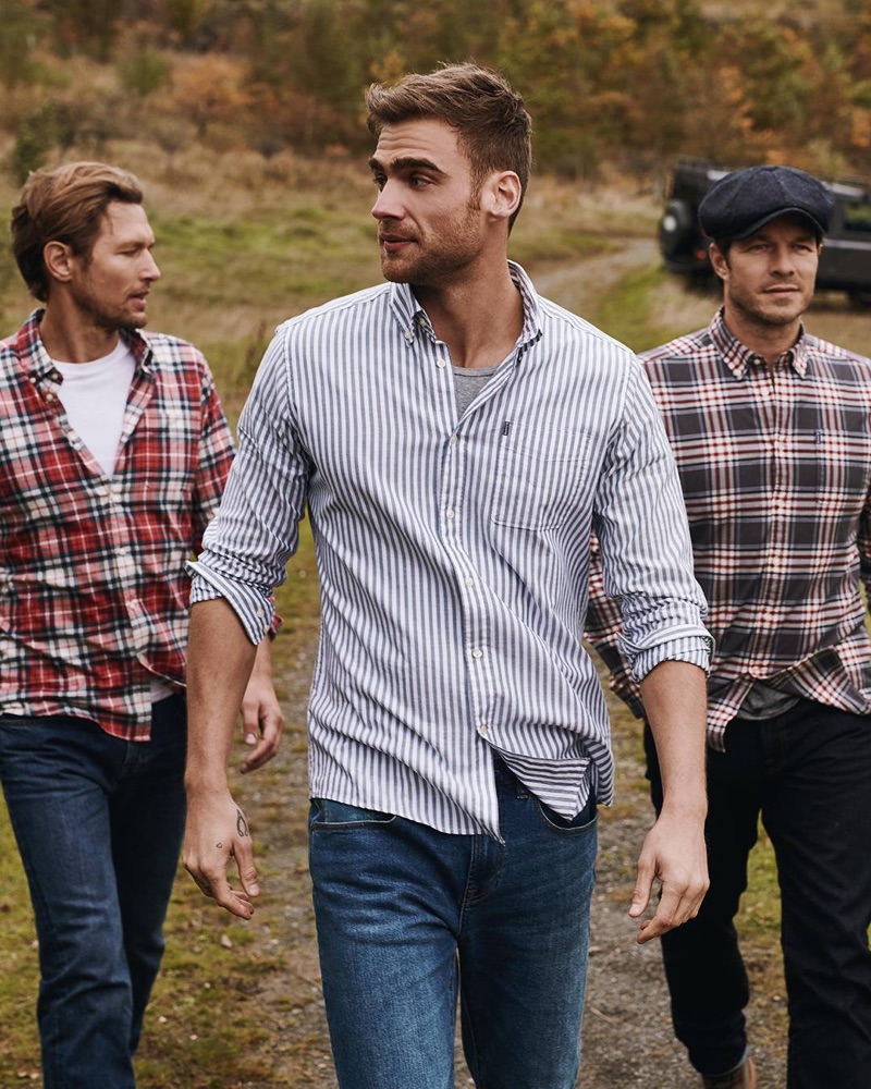 Robertas Aukstuolis, George Alsford, and Paul Sculfor wear tops from Barbour's fall 2019 Shirt Department collection. 