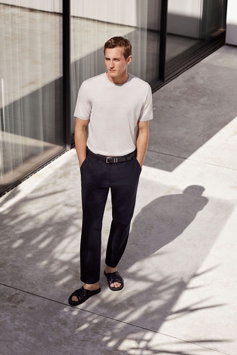 Embracing minimal style, Rutger Schoone wears a white fitted tee with black trousers by COS.