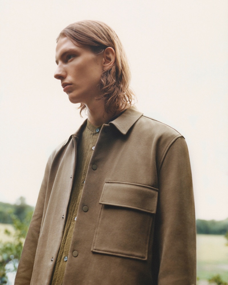 Donning a neutral-colored outfit, Casper Plantinga wears a fall 2019 look from COS.