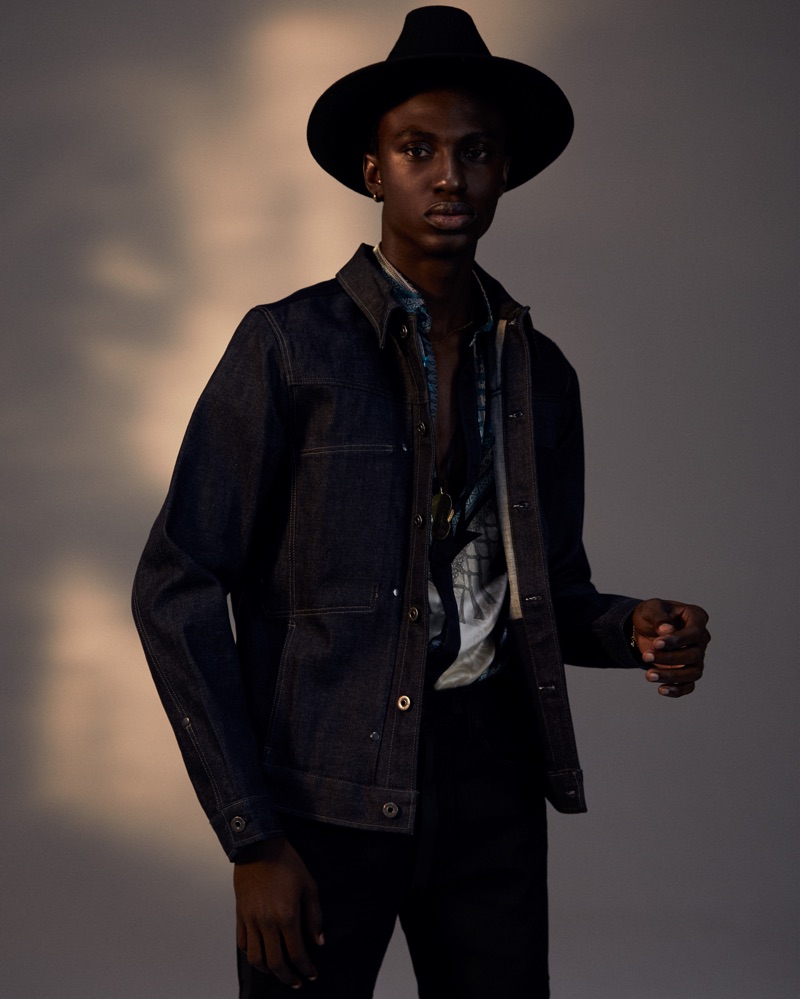 Fiifi wears jacket G-Star RAW, shirt Versace, and hat Crystal Birch.